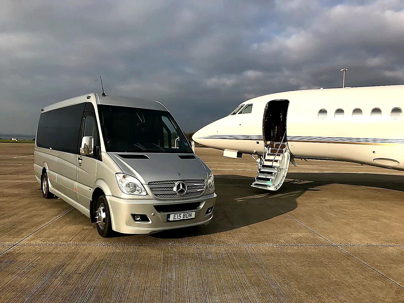 Bon Voyage Sprinter beside a private aircraft